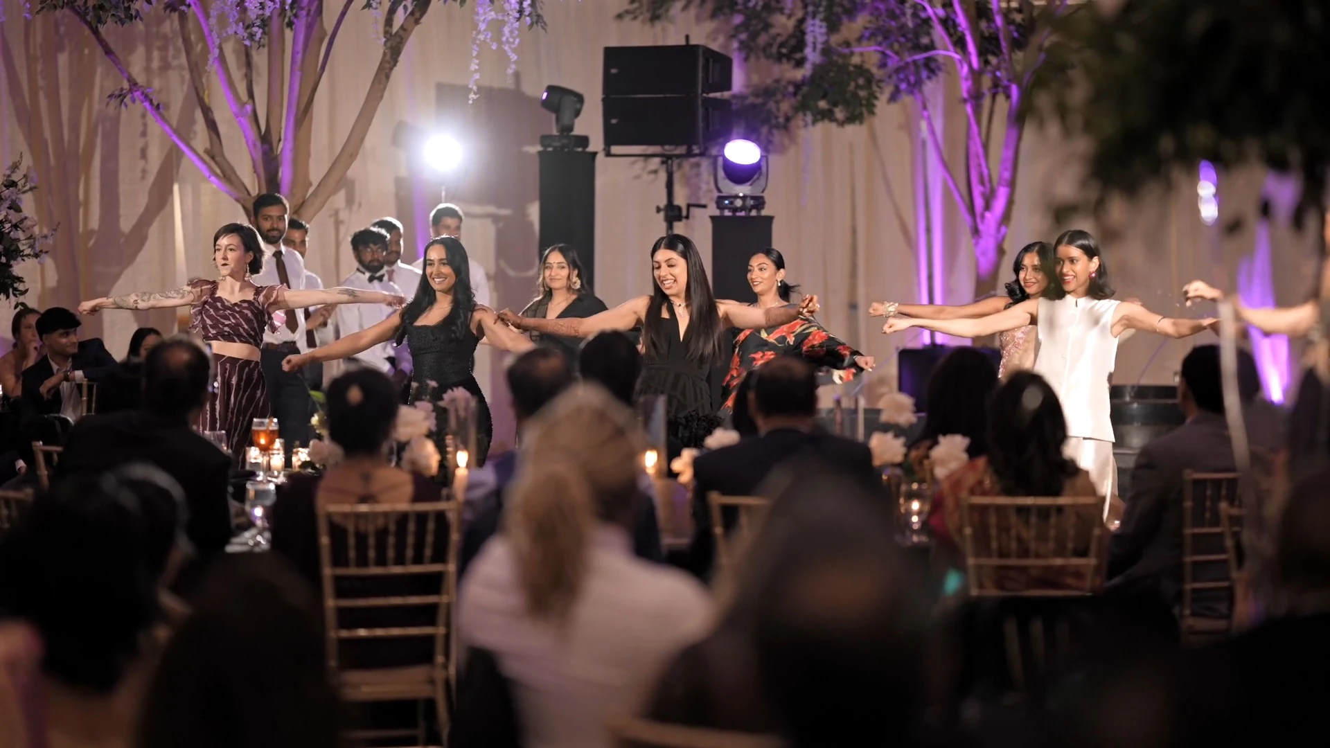 Wedding guests joyfully dancing together